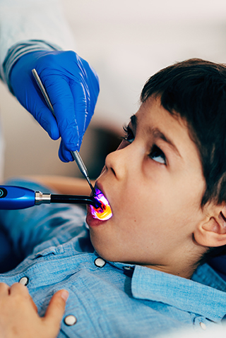Dentist looking in child's mouth